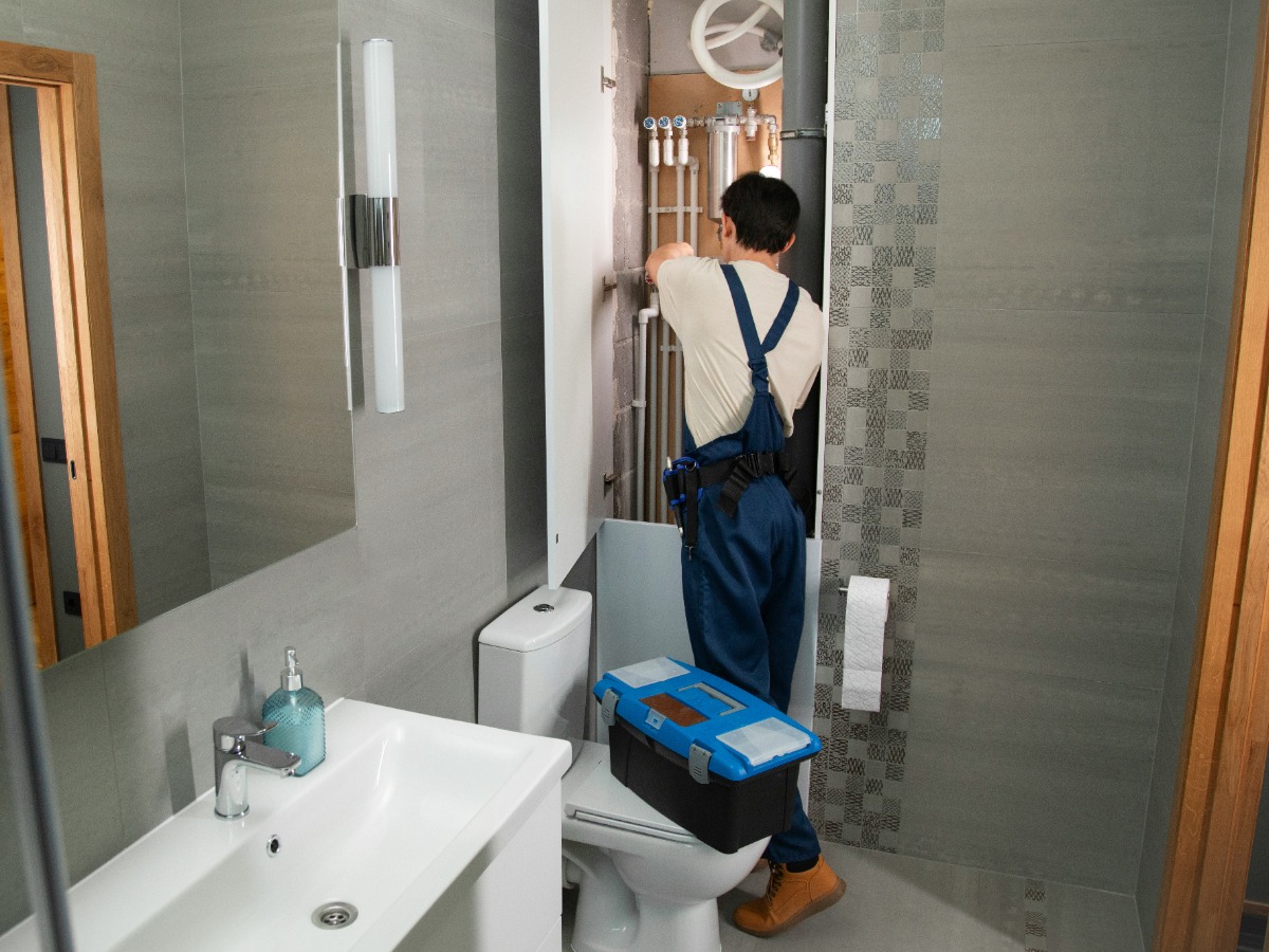 Plumber working on household plumbing
